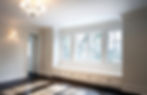 Empty modern room with large windows providing natural light.