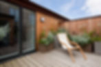 Home with a spacious deck and large energy-efficient doors.