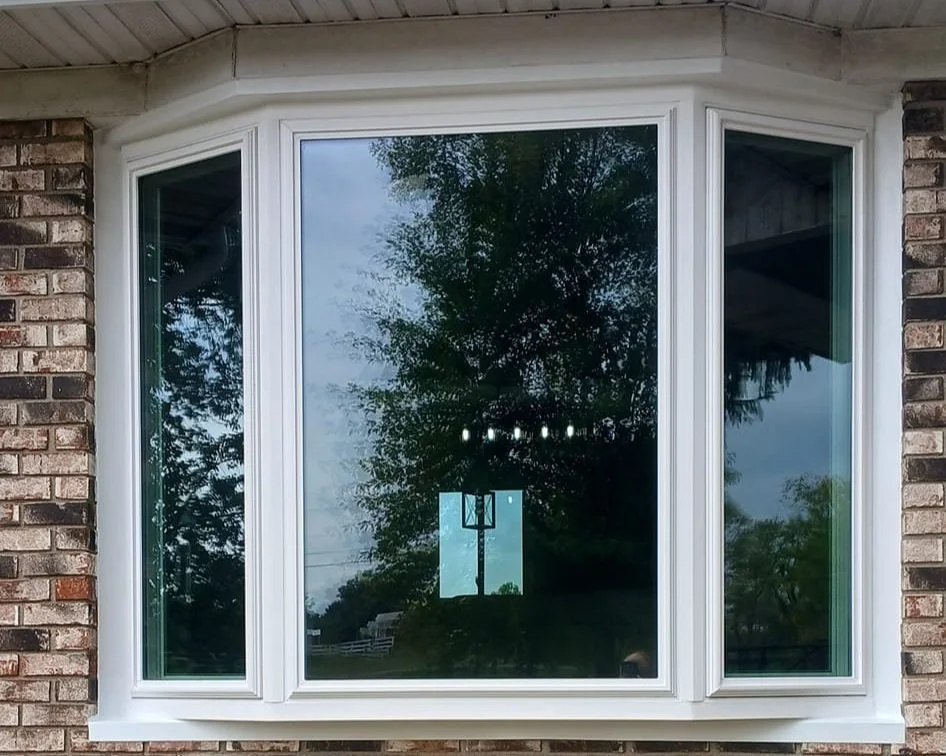 Bay window on brick house exterior.