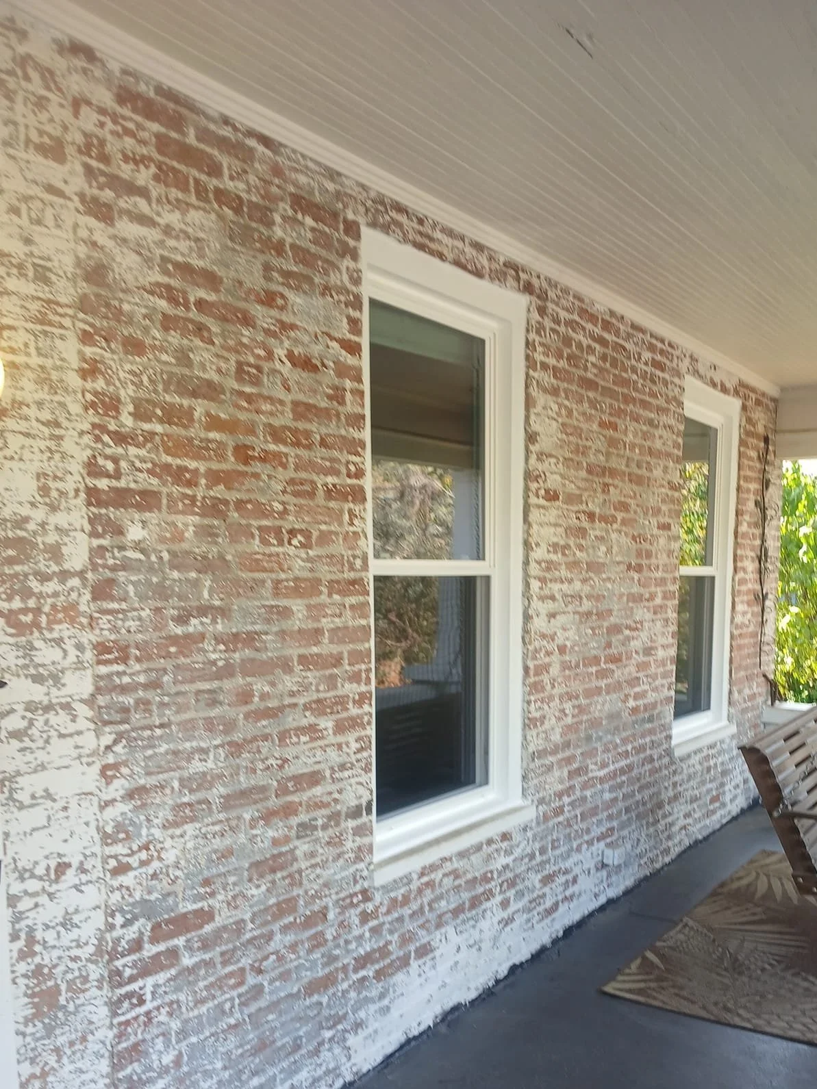 Red brick wall with white distinct windows.